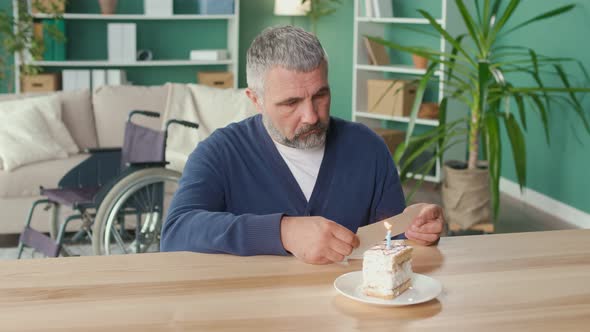 A Depressed Elderly Man with a Disability Celebrates The Holiday Alone