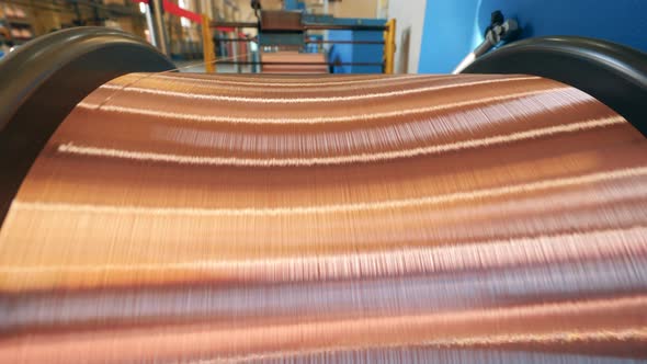Close Up of Copper Wire Getting Reeled Onto a Massive Spool