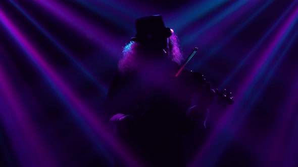 A Virtuoso Performance By a Violinist in a Dark Studio with Blinking Blue Violet Beams of Light