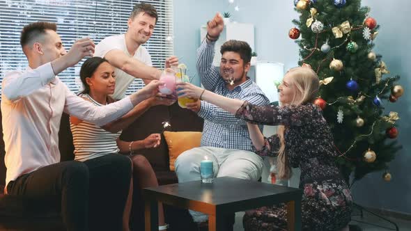 Multiracial Friends Celebrating Winter Holidays with Sparklers and Dry Ice Cocktails