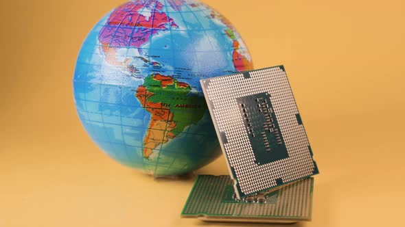 World Globe and Microprocessors Against an Orange Background
