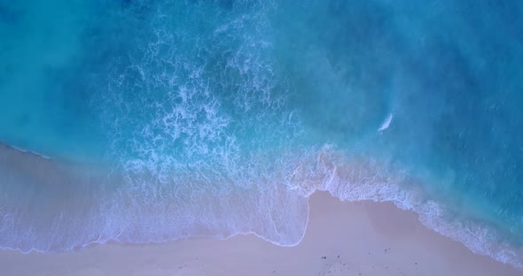 Big white waves of azure sea foaming over pink sand of exotic beach in Bermuda, beautiful sea textur