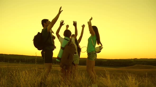 Travelers Teamwork. Family of Travelers Rejoice at Their Victory on the Top of the Hill. Tourists