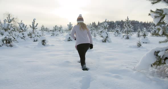 Woman Walking in Deep Snow on Sunny Winter Day Slow Motion Gimbal Shot