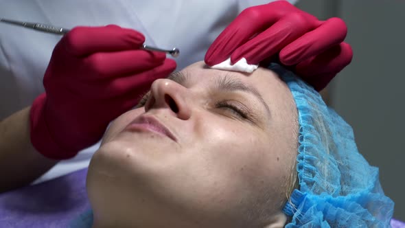 Close-up of beautician doing face cleaning treatment using mechanical instrument.