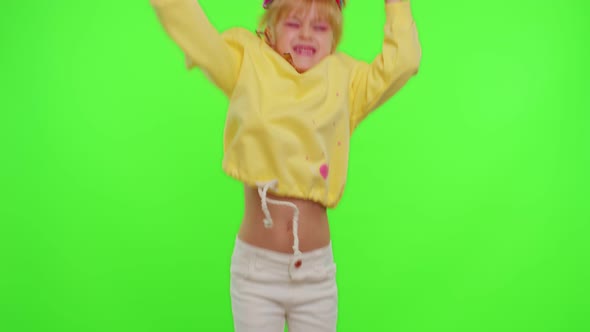 Cheerful Funny Little Teen Girl Kid Dancing at Camera Filming Video Using Phone on Chroma Key Wall