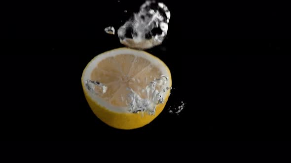 Lemon Falling into Water Super Slowmotion, Black Background, lots of Air Bubbles, 4k240fps