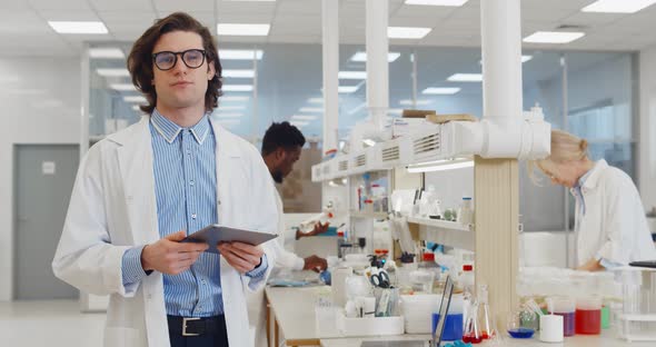 Chemist Using Tablet Computer in Lab Talking on Camera