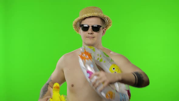Shirtless Man Tourist Walking with Swimming Ring and Duck Toy. Chroma Key