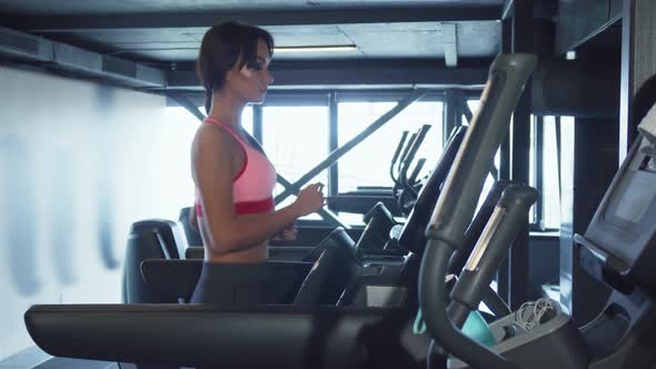 The Cute Girl Is Running on a Treadmill