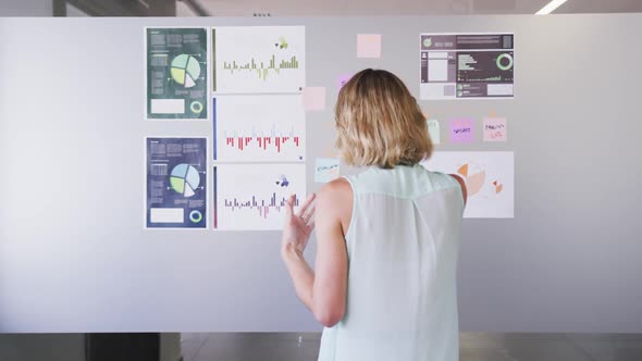 Professional businesswoman talking on the phone while standing in modern office in slow motion