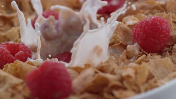 Closeup of raspberries splashing into bowl of cereal in slow motion; shot on Phantom Flex 4K at 1000