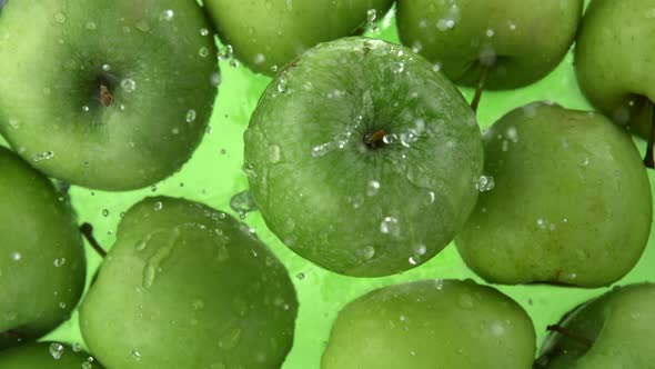 Super Slow Motion Shot of Fresh Green Apple Falling and Splashing Into Water at 1000Fps