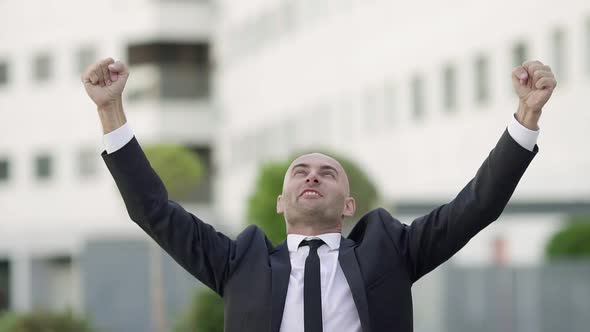 Happy Bald Office Employee Celebrating Successful Deal or Profit