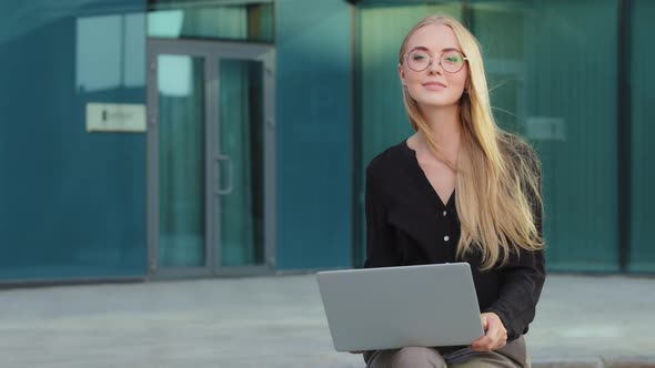 Portrait Caucasian European Blonde Smiling Woman Sitting Outdoors with Laptop Happy Attractive