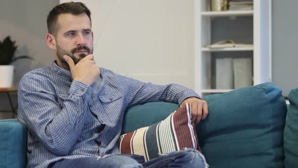 Pensive Thinking Casually Sitting Man