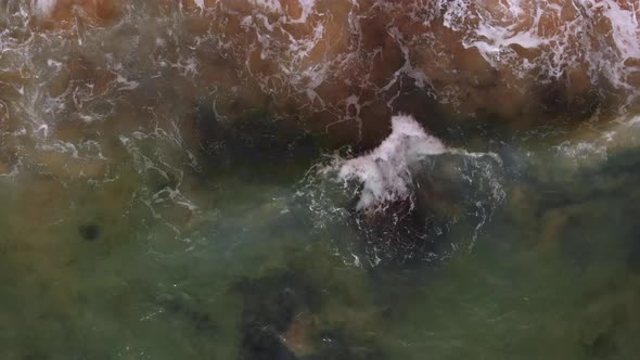 Waves Crashing onto Rocky Shore of Port of Portimao - Aerial