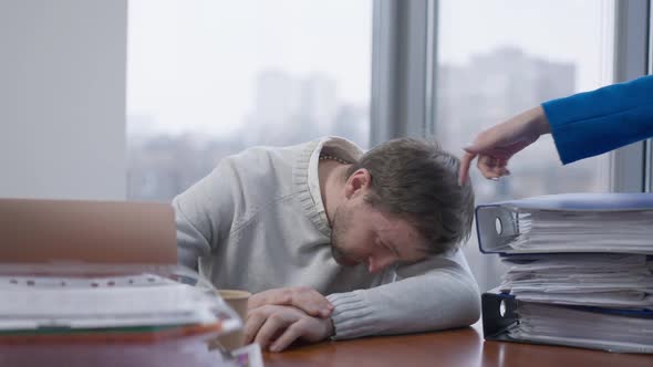 Female Hand Waking Up Sleeping Employee in Office