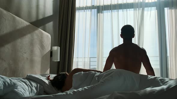 Couple Wakes Up in Bed in the Morning