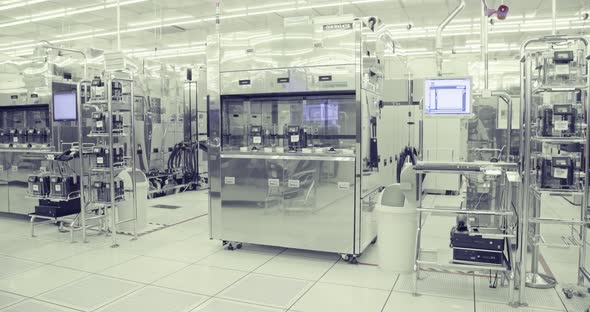 Workers in clean suits in a Semiconductor manufacturing facility