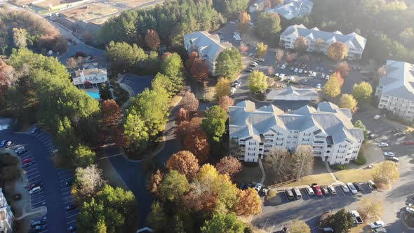 A car driving through an apartment complex in the morning in Woodstock Georgia. Aerial.