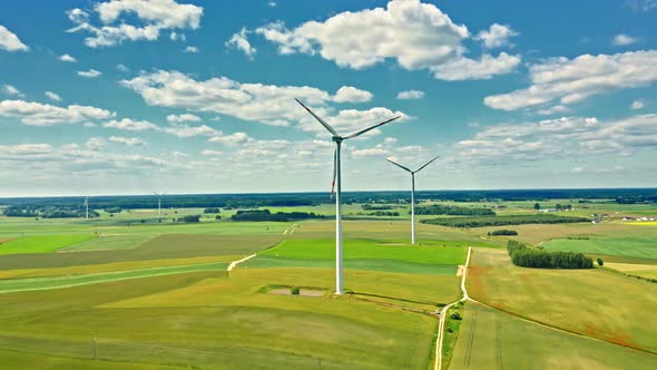 Wind turbines on green field in sunny summer day