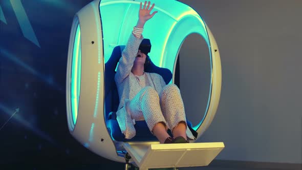 Emotional Woman Experiencing Virtual Reality in a Moving Interactive Chair