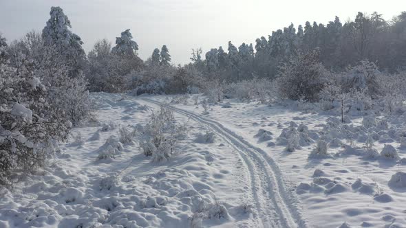 Slow descending on relaxing scene with snow over the hill 4K drone video