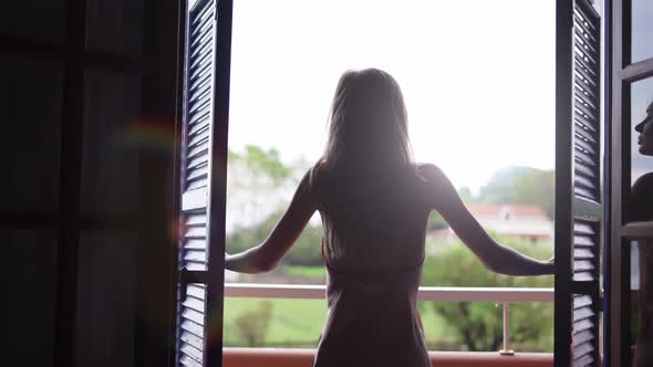 Girl Opens the Shutters in the Morning and Go Out to the Terrace