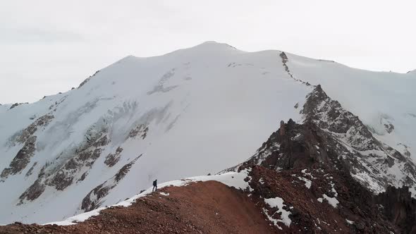 Man Walking at the Mountain Summit Aerial Landscape