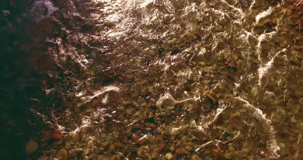 Low Altitude Flight Over Fresh Fast Mountain River with Rocks at Sunny Summer Morning.