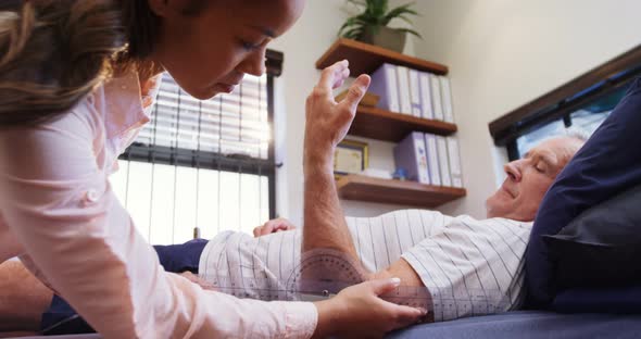 Physiotherapist measuring patient hand with medical ruler 4k