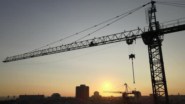 Construction Crane on a Construction Site in the City at Sunrise. Kyiv, Ukraine. Aerial View