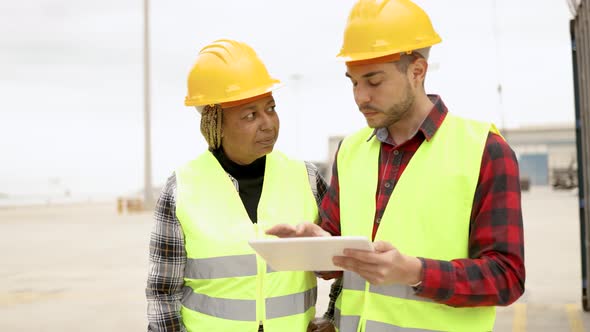 Industrial Multiracial Operators Working at Container Freight Cargo Logistics Terminal