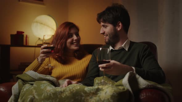 Couple Drink Red Wine On Sofa