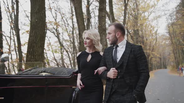 Retro Style of Romantic Couple's Walk Under the Arms in Park at Cabriolet