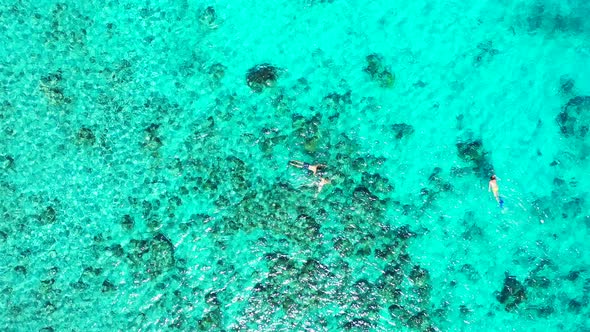 Daytime birds eye abstract view of a summer white paradise sand beach and aqua blue water background