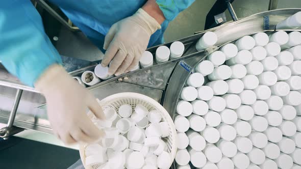 Factory Employee is Closing Pill Bottles and Displacing Them