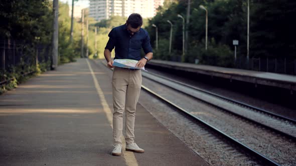 Businessman Tourist Looking On City Paper Map And Exploring City Route. Active Lifestyle On Vacation