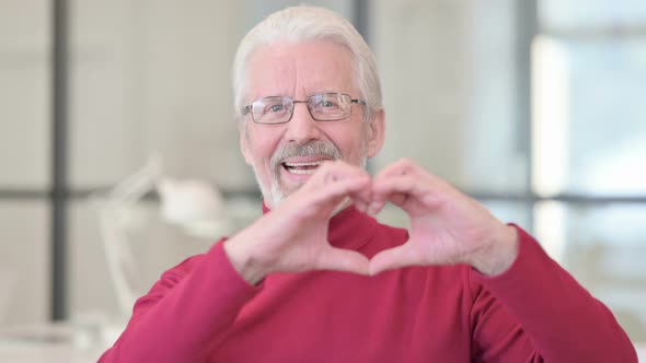 Old Man Showing Heart Sign By Hand