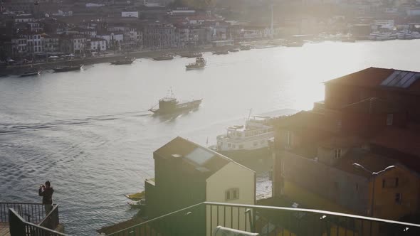 Stunning sunlight shines bright over Douro river with boats in Porto City, slow