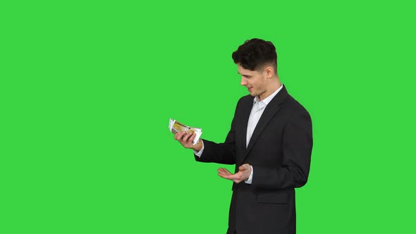 Young Happy Businessman Dancing After Counting Salary Win Dance on a Green Screen, Chroma Key