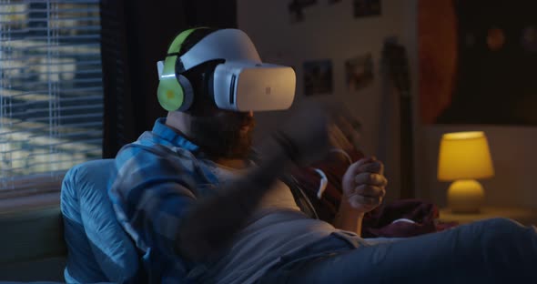 Man Wearing VR Headset in Bed