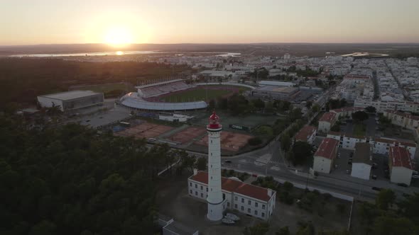 Sunset aerial around Vila Real de Santo Antonio lighthouse, Portugal