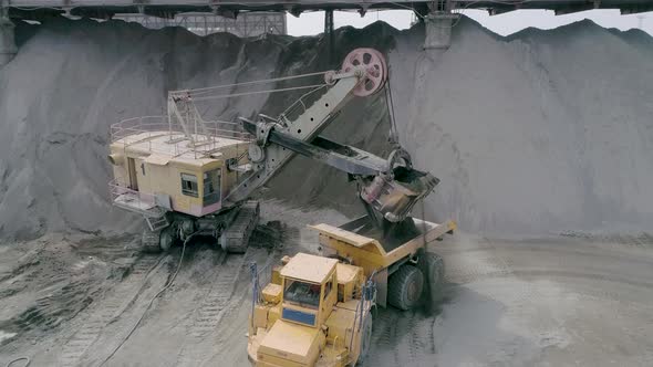 Heavy Mining Equipment Excavators, Large Dump Trucks, Front Loaders Working on Production of Stone
