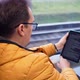 Profile Portrait of Mature Guy in Glasses Reads an Electronic Book While Riding Home By Train - VideoHive Item for Sale