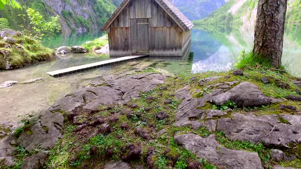 Path to a wooden cabin on a mountain lake Obersee, German Alps