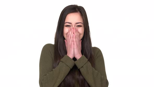 Portrait of Young Smiling Woman 20s Expressing Happiness and Surprise Covering Open Mouth with