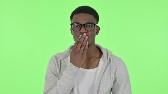 Flying Kiss By African Man on Green Background