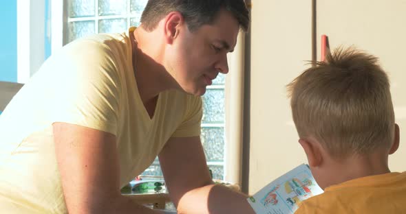 Father Reading Book to His Son